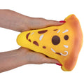 Two hands squeezing a triangular pizza-shaped foam squishy toy with yellow cheese and brown toppings.
