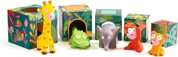 Colorful rubber jungle animals stand in front of five green, leaf-patterned nesting blocks with arched cutouts.