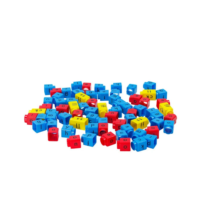 A pile of blue, red, and yellow plastic cubes with black lowercase letters and phonetic sounds printed on them.