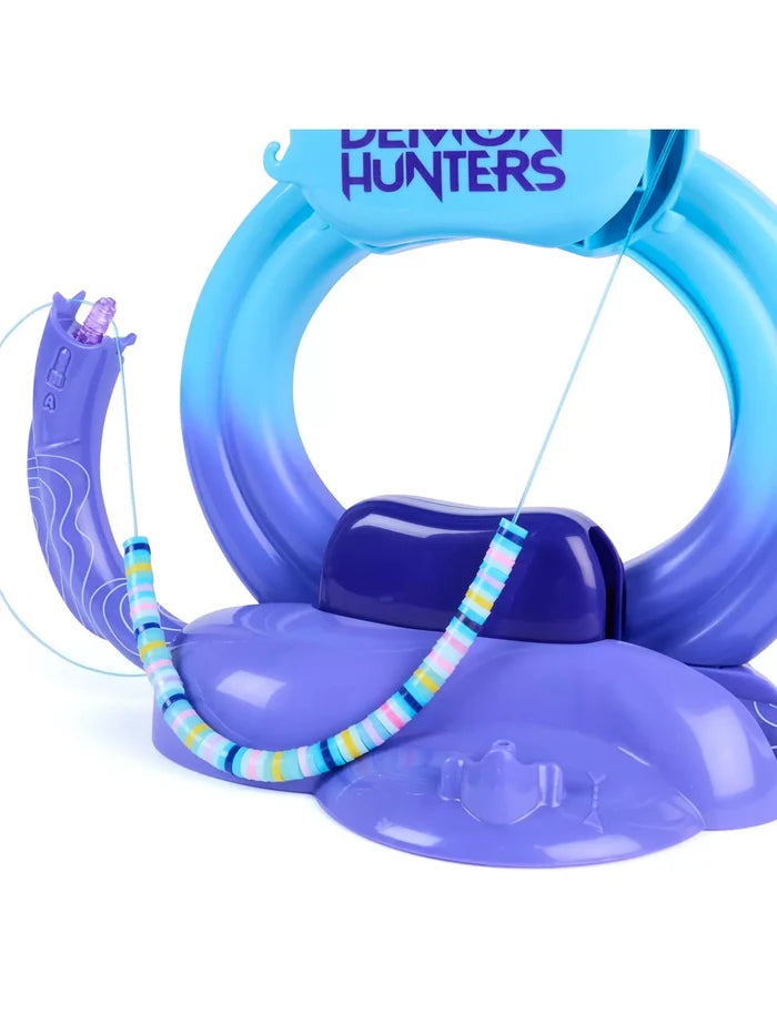 Purple and blue plastic bracelet maker with colorful disc-shaped heishi beads being threaded onto a blue string.