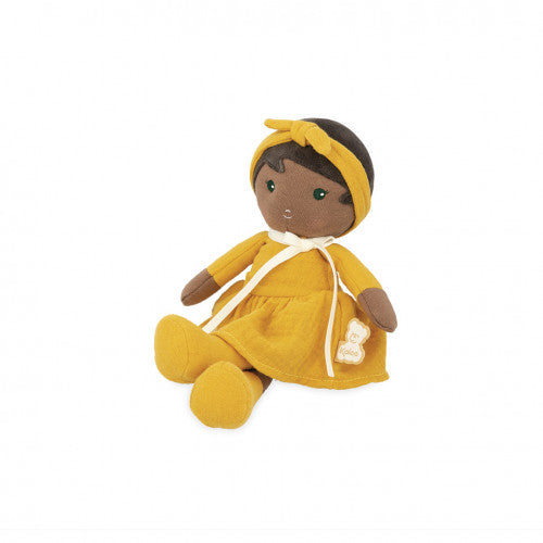 Plush doll with brown skin wearing a mustard yellow dress and matching headband, seated against a white background.