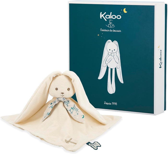 Cream ribbed rabbit plush with a patterned blue scarf, beside its dark teal and white square gift box.