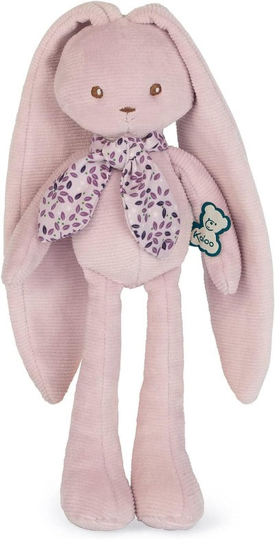 Pink ribbed plush rabbit with long ears and legs, wearing a purple floral scarf and a Kaloo brand tag.
