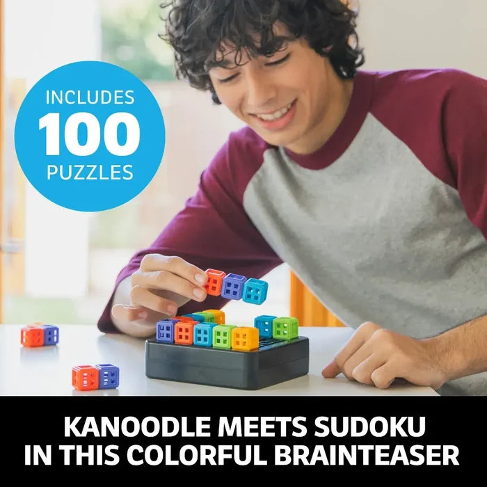Teen boy placing colorful square blocks onto a 3D puzzle grid. Text says Includes 100 Puzzles.