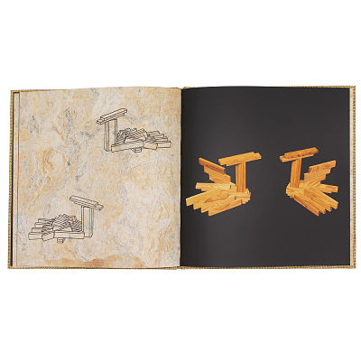 Open book with beige and black pages showing line drawings and color illustrations of wooden block structures.