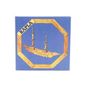 Square blue book cover with an octagonal wooden frame surrounding a model ship built from wooden planks.
