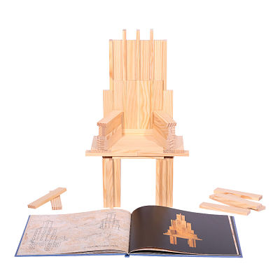 Wooden plank chair behind an open blue art book with building designs and loose planks on a white background.