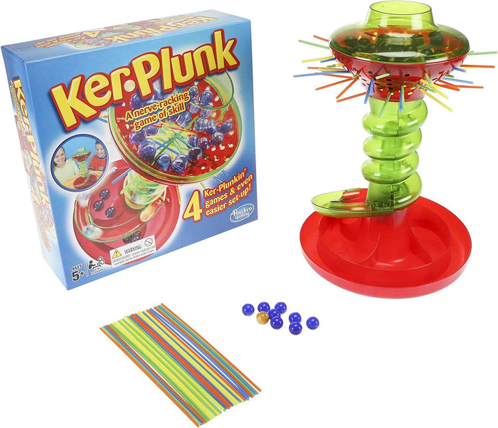 KerPlunk game box beside a red and green plastic tower, colorful sticks, and small blue and gold marbles.