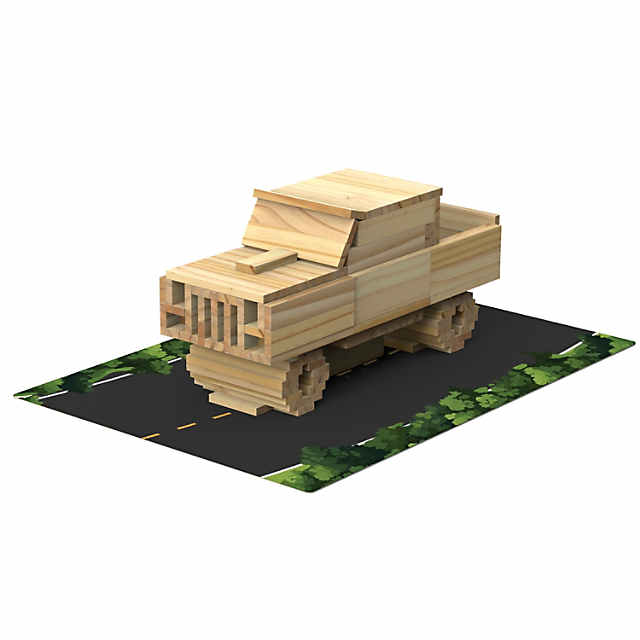 A wooden truck model built from light natural wood planks on a road graphic with green foliage.