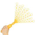 Hand holding a yellow plastic bubble toy with ten fanned-out wands, each containing multiple circular rings.