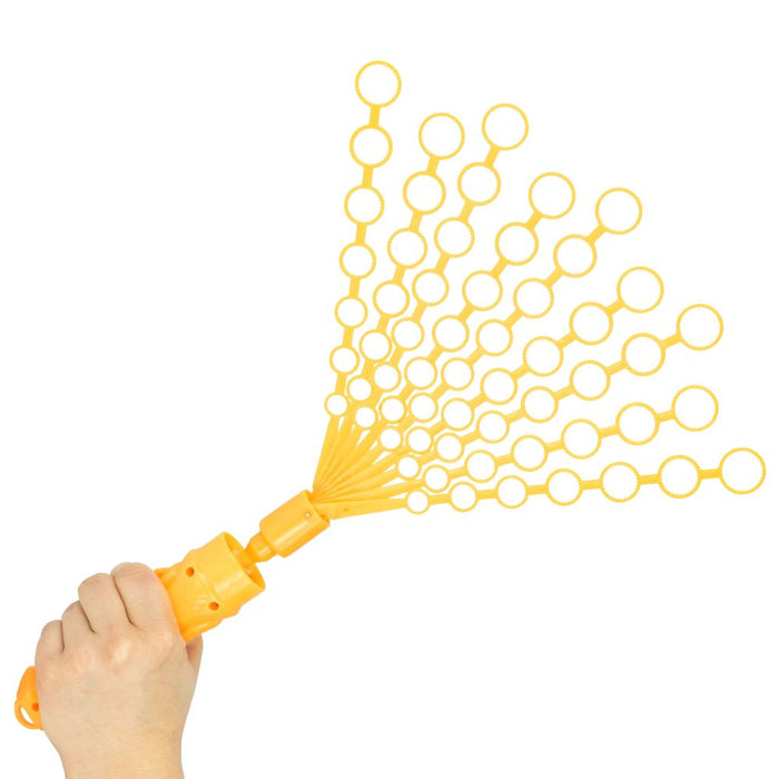 Hand holding a yellow plastic bubble toy with ten fanned-out wands, each containing multiple circular rings.