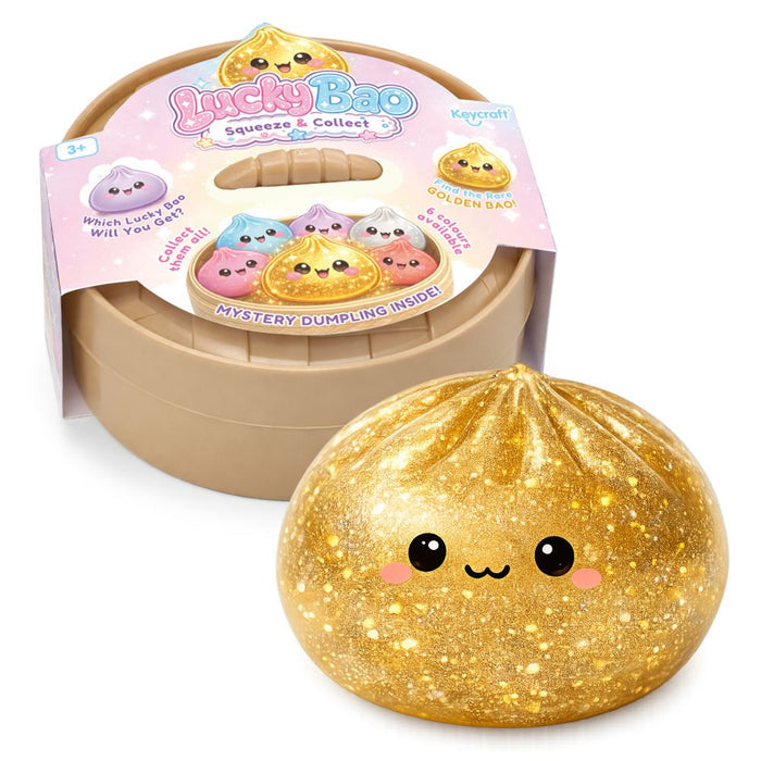 Sparkly gold dumpling squeeze toy with a cute face next to its tan steamer-style container and colorful packaging wrap.