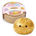 Sparkly gold dumpling squeeze toy with a cute face next to its tan steamer-style container and colorful packaging wrap.