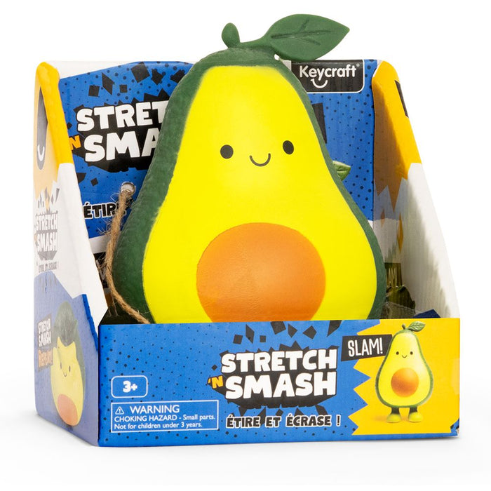Smiling green and yellow avocado squeeze toy with a leaf top in a blue and yellow Stretch 'N Smash branded display box.