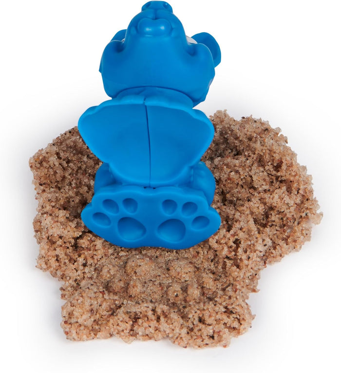 Blue dog figure with a large paw print base resting on a mound of tan kinetic sand.