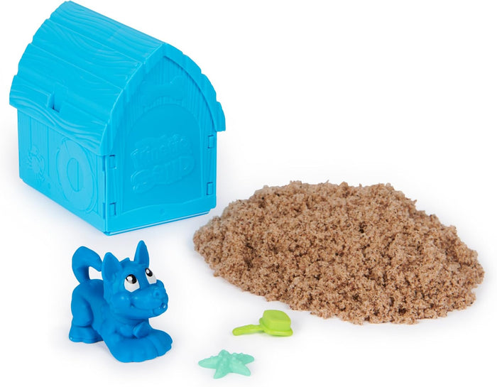 Blue doghouse-shaped container, blue dog toy, pile of brown sand, green starfish and bone-shaped sand tools.