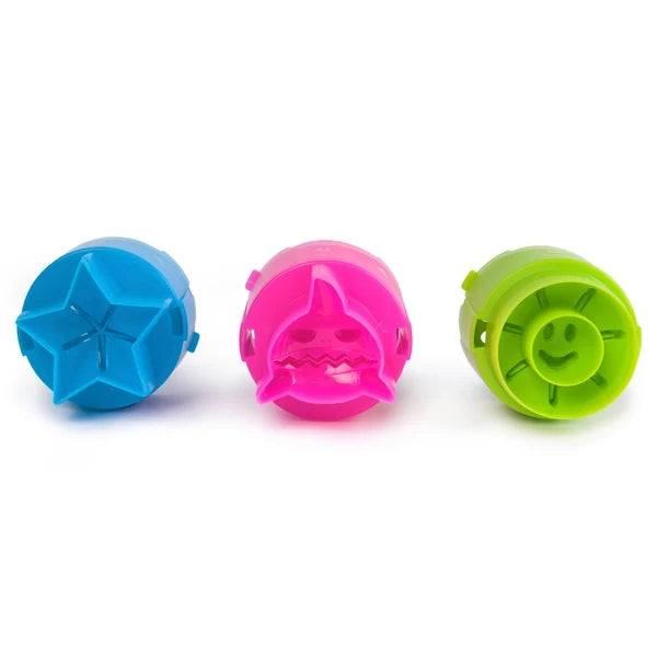 Three colorful plastic sand stamps: a blue star, pink shark, and green sun with a smiley face.