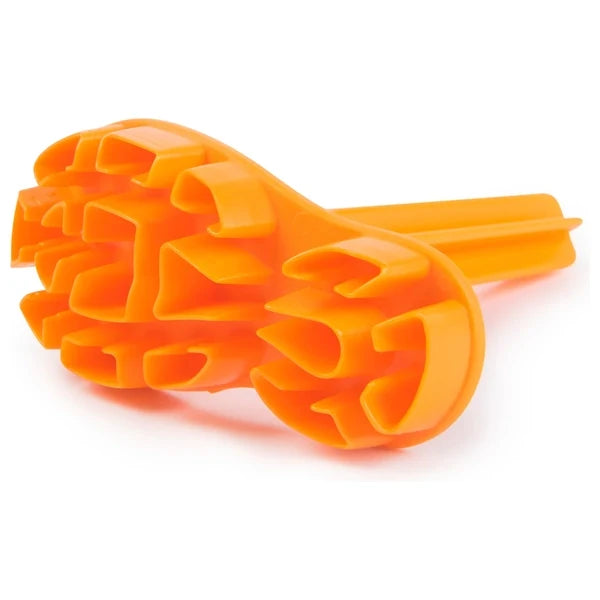 Bright orange plastic stamping tool with a patterned face of various hollow shapes and a long handle.
