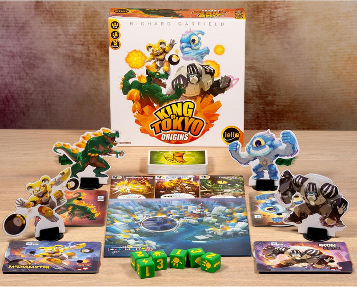 Vibrant board game set with monster standees, green dice, and player cards displayed in front of a white illustrated box.