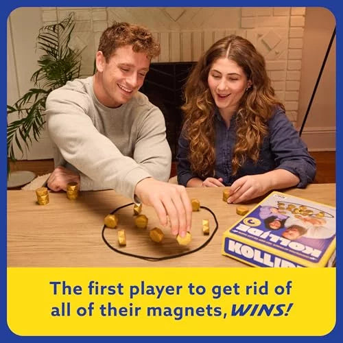 Two people play with gold magnets inside a black string loop on a table. Blue and yellow game box shown nearby.