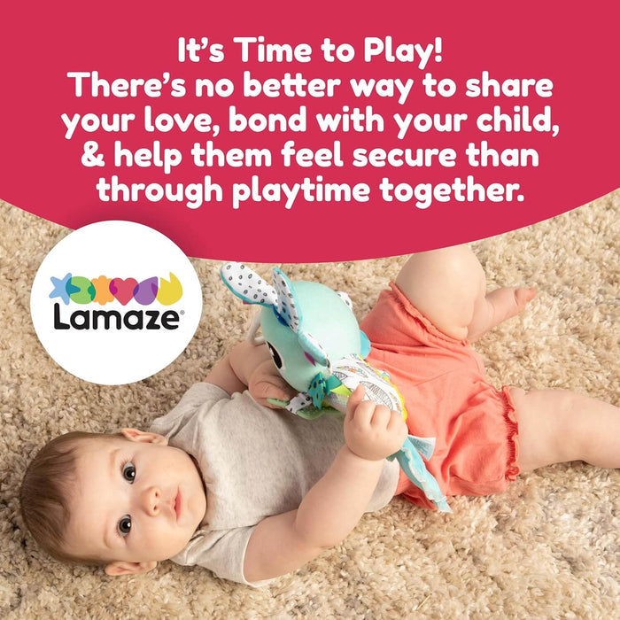 Baby on a cream rug holding a teal plush axolotl toy. Lamaze logo and Time to Play text on a pink background.