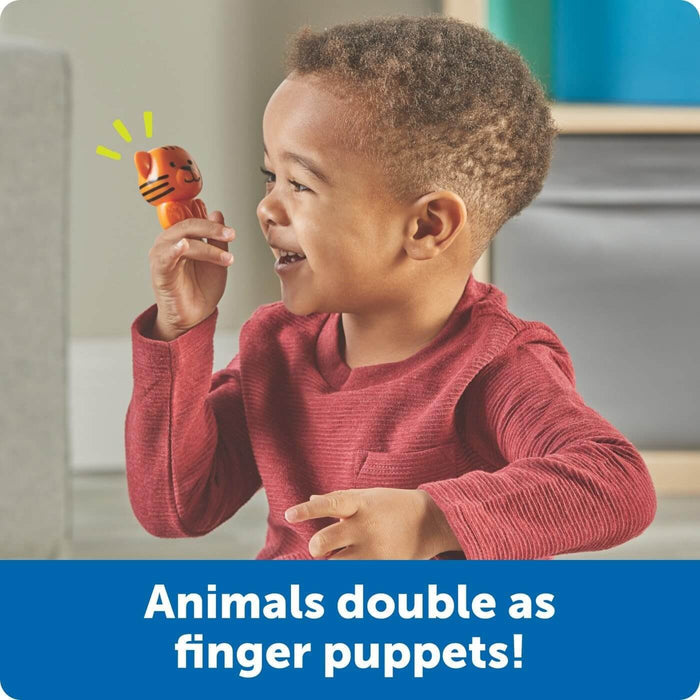 Smiling toddler holding an orange tiger finger puppet. Text: Animals double as finger puppets!