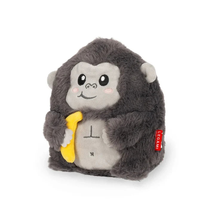 Round dark gray plush gorilla with a light gray face and belly, holding a yellow banana. Red brand tag on the side.