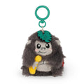 Fluffy grey gorilla plush clip-on toy holding a banana with a leaf on its head saying 'Wild But Kind'.