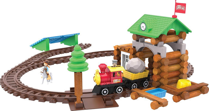 Log station with green roof, red steam train on brown tracks, toy cowboy on white horse, and green pine tree.