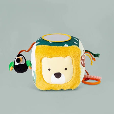 A plush yellow activity cube featuring a bear face, a top-mounted mirror, and an attached toucan and teething ring.