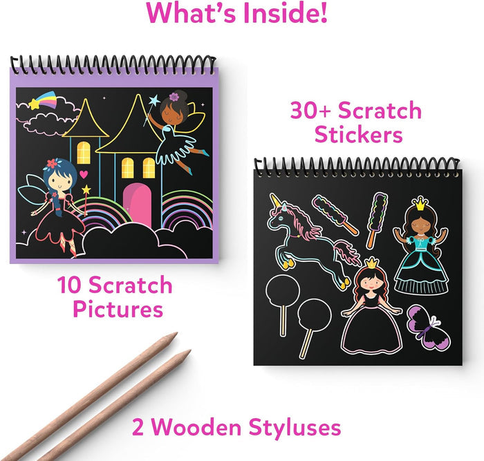 Two spiral books with black scratch-off pages of fairies and unicorns, plus two wooden drawing styluses.