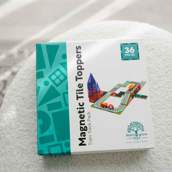 Square white and teal box for a 36-piece train track set, showing a colorful track illustration on a white fuzzy surface.