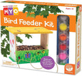 Orange box showing a painted wooden bird feeder with birdseed and a row of colorful paints with a brush.