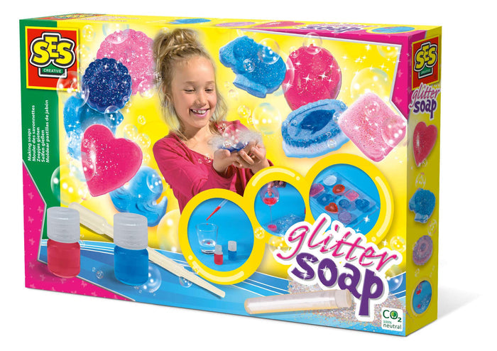 Colorful box for SES Creative Glitter Soap with pink and blue shaped soaps, a smiling girl, and craft supplies.