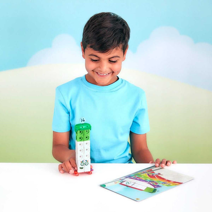 A smiling boy builds Numberblock Fourteen using green and white snap cubes next to a colorful activity card.