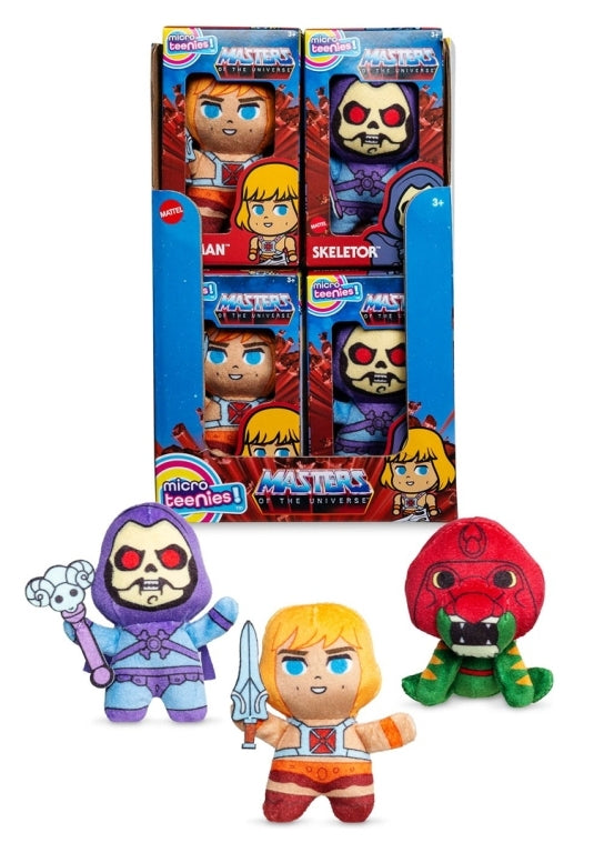 Masters of the Universe display box with small plushies of blonde He-Man, purple Skeletor, and a red snake creature.