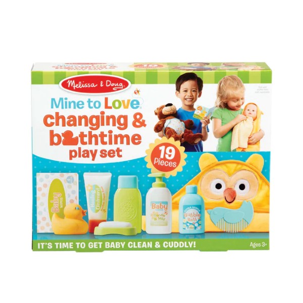 Melissa & Doug toy box showing a yellow owl hooded towel, rubber duck, lotion bottles, and children playing.
