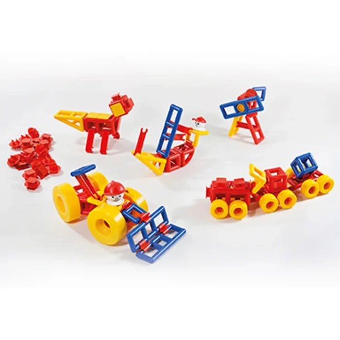 Red, yellow, and blue geometric plastic building blocks assembled into a toy tractor, train, and other structures.