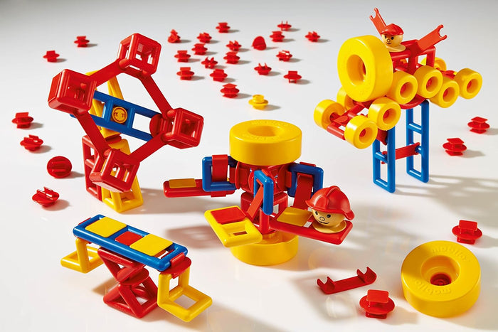 Colorful red, yellow, and blue plastic building blocks and wheels built into several toy models on a white background.