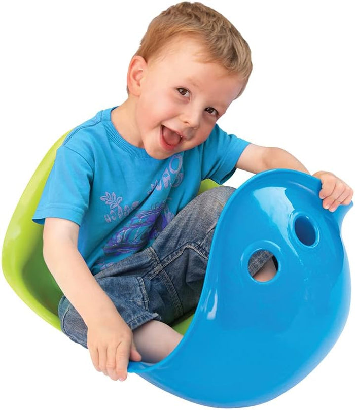 Smiling child sits in a blue shell-shaped toy with two holes, nested on top of a lime green version.