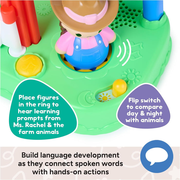 Close-up of a green toy farm base with a Ms. Rachel figure, yellow music button, and a sun and moon day-night switch.