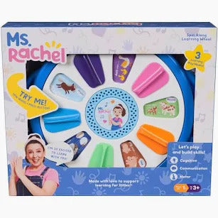 Ms. Rachel Spin Along Learning Wheel toy in packaging, featuring a blue circular toy with colorful tabs and animal icons.