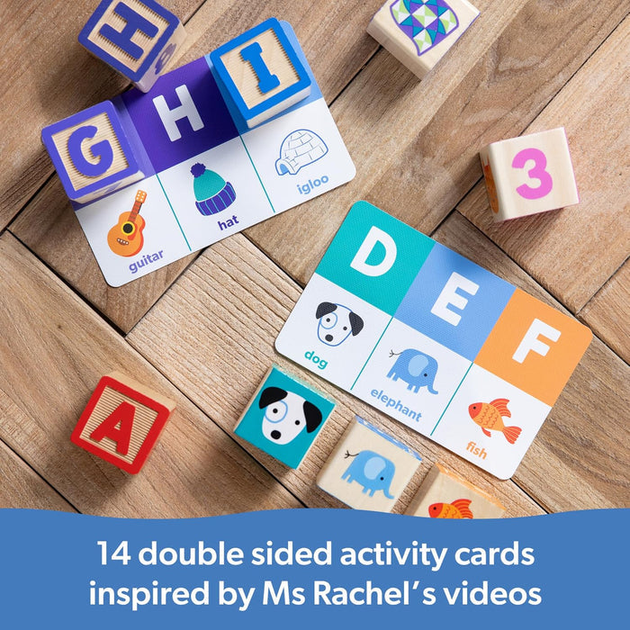 Wooden letter blocks and matching illustrated activity cards featuring animals and objects on a wooden background.