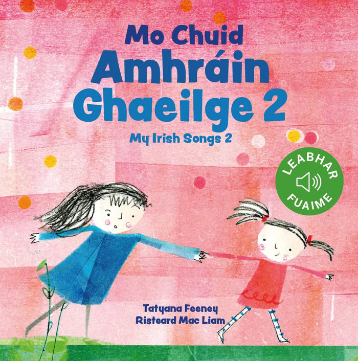 Illustrated pink book cover showing two hand-drawn girls holding hands, titled Mo Chuid Amhráin Ghaeilge 2.