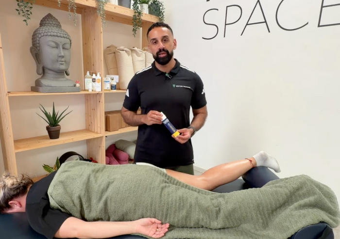 A sports massage therapist presenting NAQI Recovery Gel, available from Massage Warehouse for clinic professionals throughout the UK and Ireland; highlights the essential oil blend with arnica, peppermint, and eucalyptus designed to stimulate blood flow, reduce stiffness, and speed up muscle recovery in Southampton.