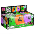Three colorful glow-in-the-dark ghost squishy toys in green, orange, and purple in a display box.