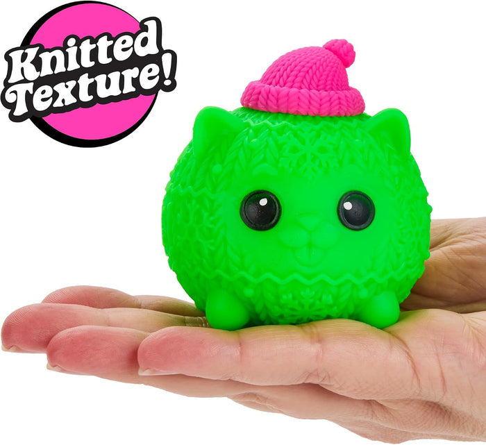 Round neon green cat squishy with a pink beanie and knitted texture held in a hand. 'Knitted Texture!' badge included.