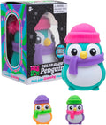 Three colorful penguin squishy toys wearing beanies and scarves next to a Polar Glow Penguin display box.