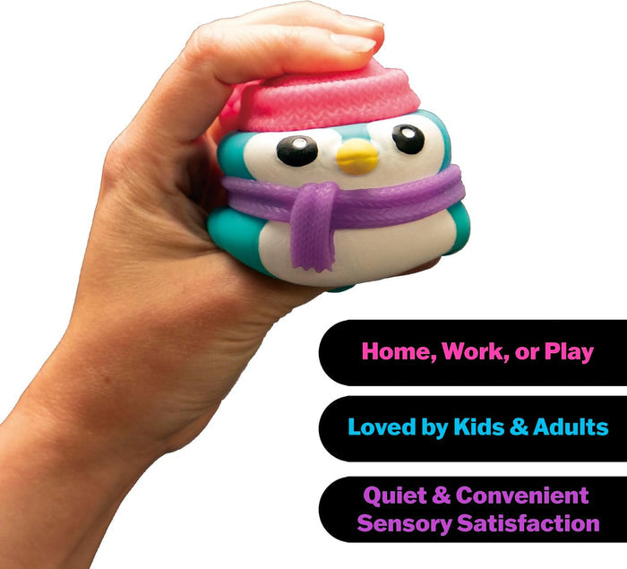 Hand squeezing a squishy teal and white penguin toy with a pink knit hat and purple scarf.