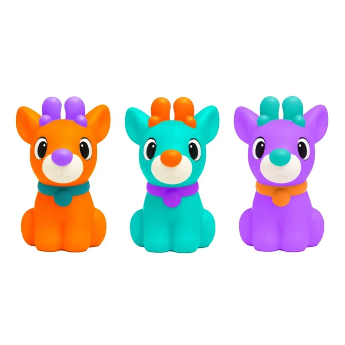 Three colorful reindeer squishy toys in bright orange, teal, and purple with contrasting antlers, noses, and collars.